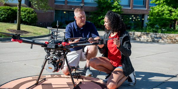 instructor teaching student to use a drone